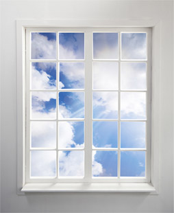 Sunny, cumulus cloud sky viewed through glistening windows. Residential window cleaning by Modern Window.